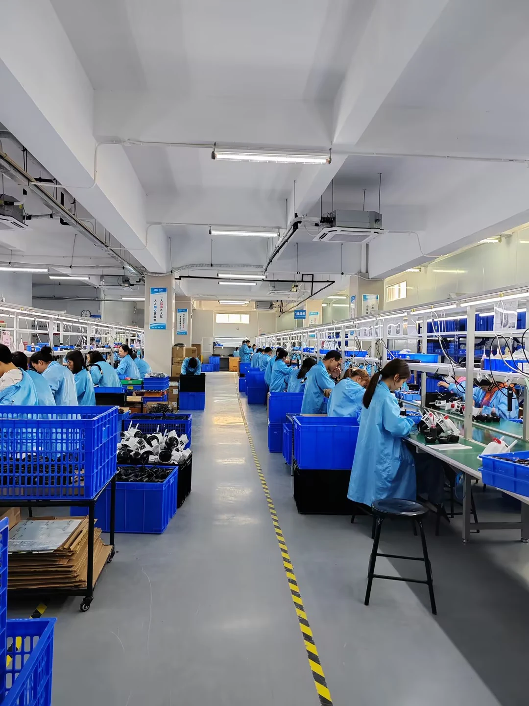 Camera assembly teams working along the production floor in Guangzhou